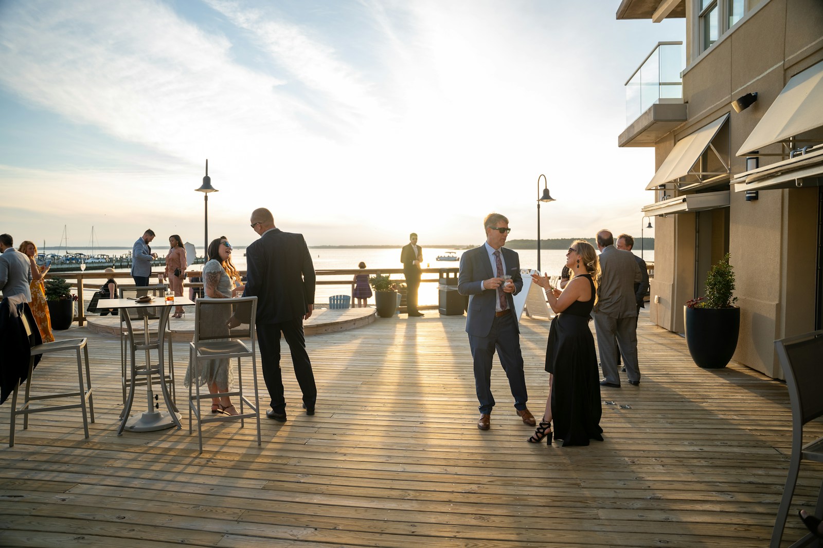 a group of people standing on top of a wooden deck